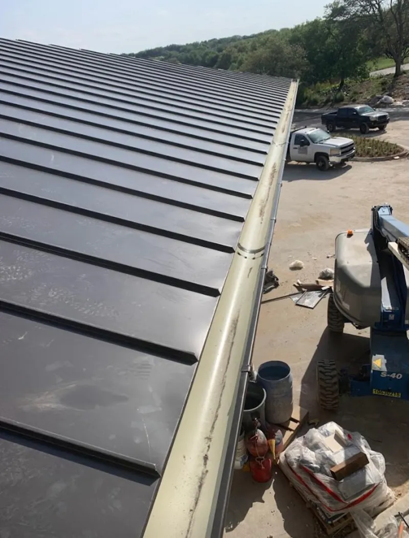 Standing seam panel and gutter detail on a metal roofing jobsite in Pittsfield